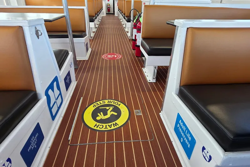 Ocean Thunder Yacht Photos Pics Interior of 1986 Gulf Craft Passenger boat with safety signs and seating.