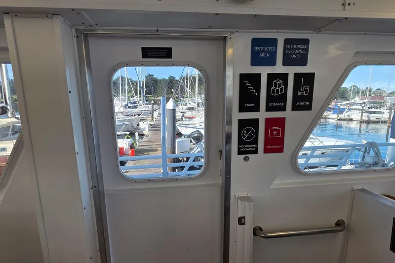 Ocean Thunder Yacht Photos Pics Interior view of a 1986 Gulf Craft Passenger boat with marina in background.