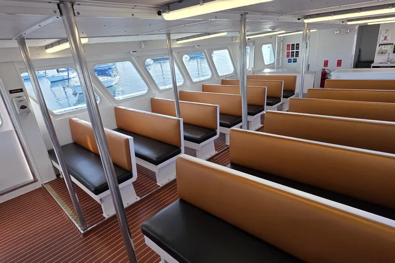 Ocean Thunder Yacht Photos Pics Interior of 1986 Gulf Craft Passenger boat with brown and black seating.