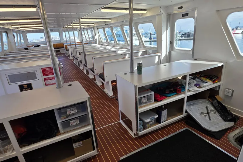 Ocean Thunder Yacht Photos Pics Interior of a 1986 Gulf Craft Passenger boat with seating and storage areas.