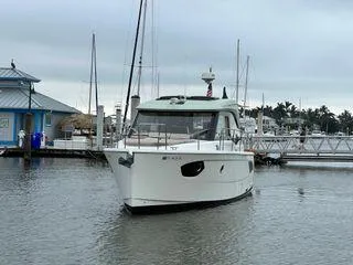  Yacht Photos Pics A white boat docked at a marina on a cloudy day.