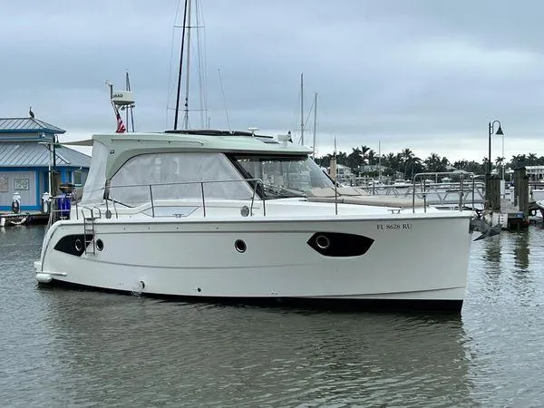  Yacht Photos Pics White Bavaria E34 Sedan boat docked in a marina, 2018 model.