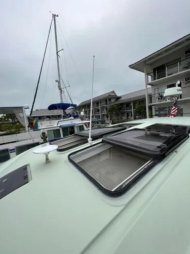  Yacht Photos Pics Bavaria E34 Sedan 2018 yacht docked at marina with open hatches and nearby sailboat.