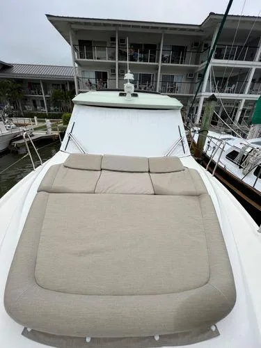  Yacht Photos Pics Luxury yacht with beige sunbed, docked at marina, Bavaria E34 Sedan 2018 model.