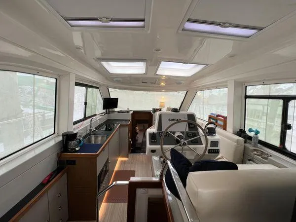  Yacht Photos Pics Luxurious Bavaria E34 Sedan interior with modern helm and kitchen, 2018 model.