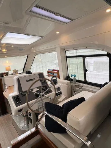  Yacht Photos Pics Luxurious Bavaria E34 Sedan 2018 yacht interior with modern navigation system and plush seating.