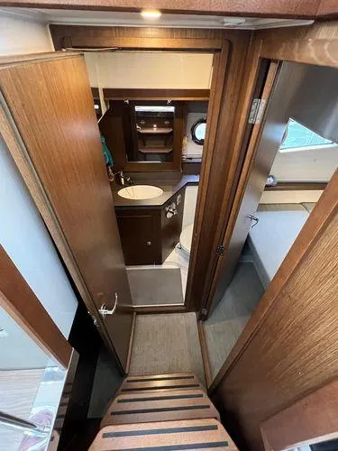 Yacht Photos Pics Interior of 2018 Bavaria E34 Sedan yacht, featuring wooden finishes and compact bathroom.