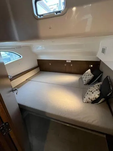  Yacht Photos Pics Cozy interior cabin of 2018 Bavaria E34 Sedan with modern bedding and window view.