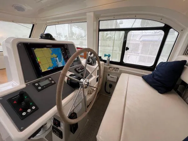  Yacht Photos Pics Interior of a Bavaria E34 Sedan boat, featuring navigation controls and seating, 2018 model.