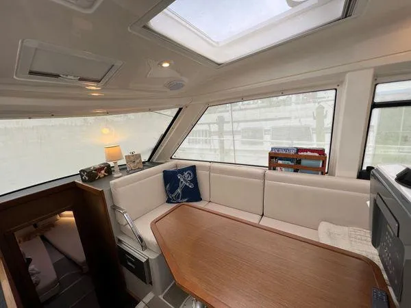  Yacht Photos Pics Luxurious Bavaria E34 Sedan 2018 interior with skylight, cozy seating, and elegant decor.