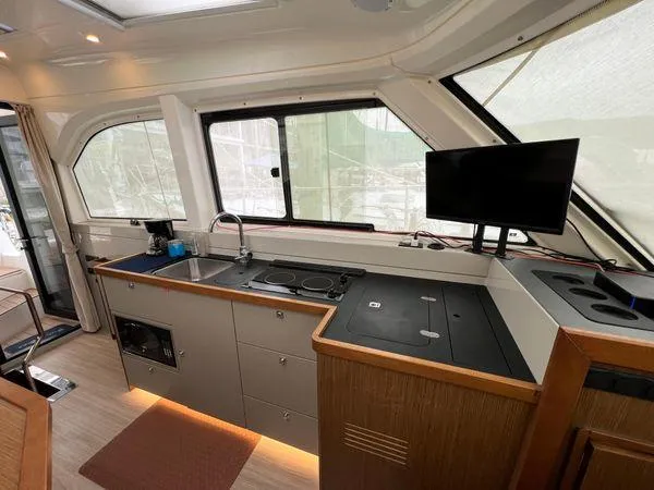  Yacht Photos Pics Modern Bavaria E34 Sedan 2018 interior with kitchenette and TV.