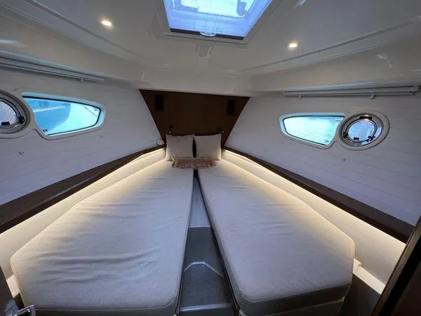  Yacht Photos Pics Luxurious Bavaria E34 Sedan 2018 cabin interior with twin beds and modern lighting.