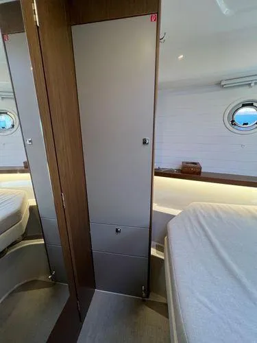  Yacht Photos Pics Interior of 2018 Bavaria E34 Sedan yacht cabin with modern design and porthole window.