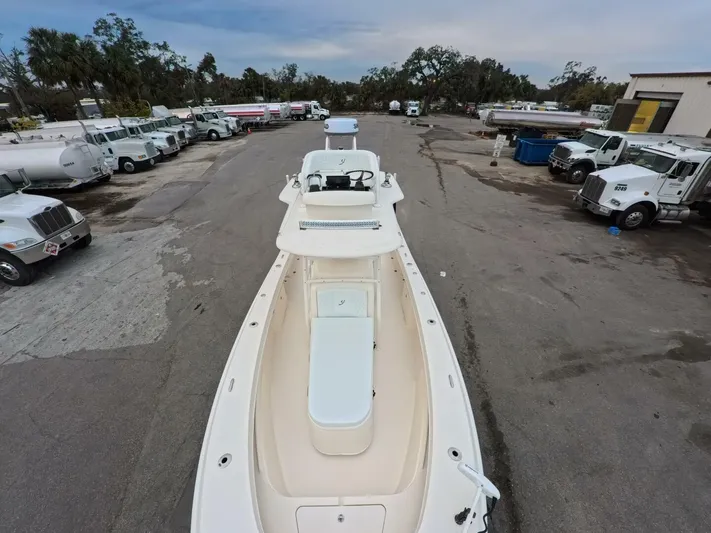  Yacht Photos Pics 2019 Young Boats 27 in a parking lot with trucks, viewed from above.