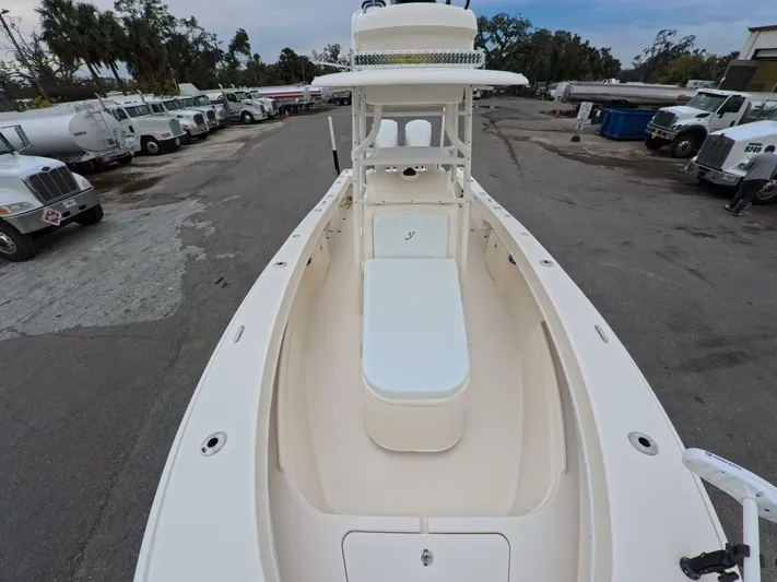  Yacht Photos Pics 2019 Young Boats 27 model, white deck view, parked in an industrial area.
