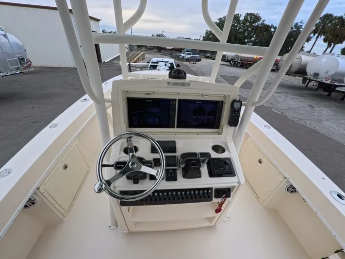  Yacht Photos Pics 2019 Young Boats 27 helm with dual screens and steering wheel, docked outdoors.