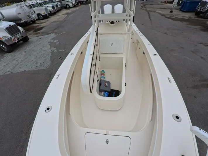  Yacht Photos Pics 2019 Young Boats 27 model, spacious deck view, parked among trucks.