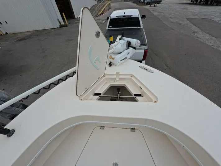  Yacht Photos Pics 2019 Young Boats 27 with open hatch and trolling motor, parked near a truck.