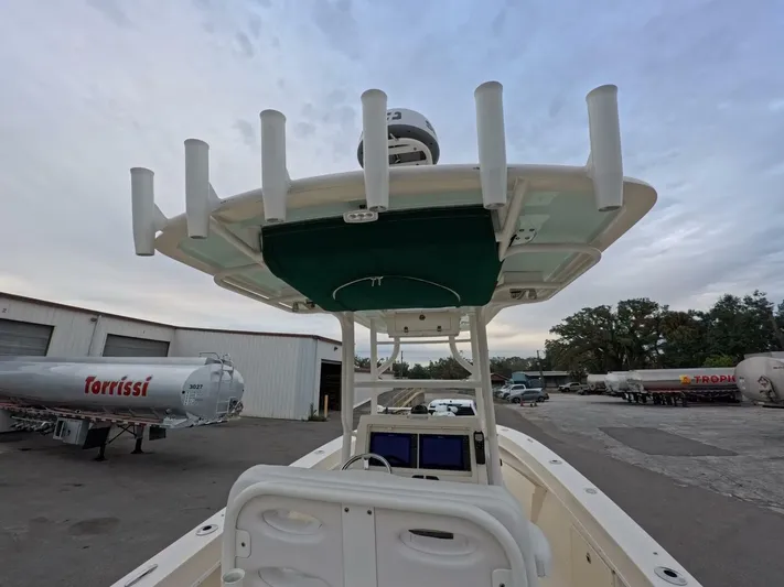  Yacht Photos Pics 2019 Young Boats 27 with T-top and rod holders, parked near trailers.