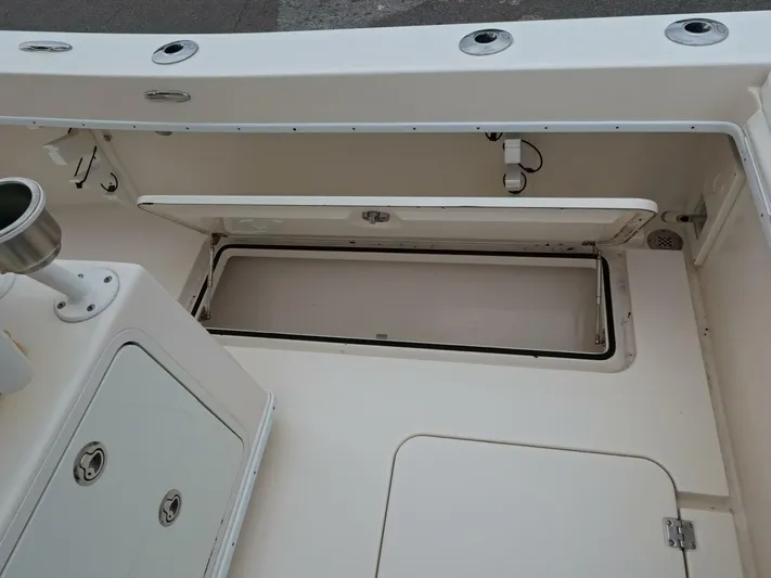  Yacht Photos Pics 2019 Young Boats 27 interior, featuring storage compartments and rod holders.
