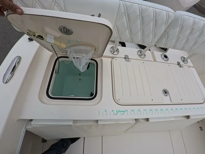  Yacht Photos Pics 2019 Young Boats 27 interior with open storage compartment and cushioned seating.