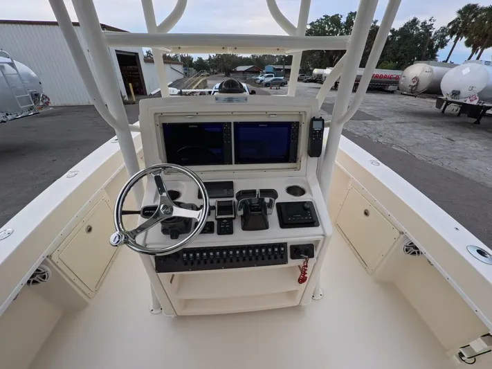  Yacht Photos Pics 2019 Young Boats 27 helm with dual screens and steering wheel, docked outdoors.