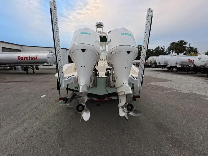  Yacht Photos Pics 2019 Young Boats 27 with dual outboard engines, parked in an industrial area.