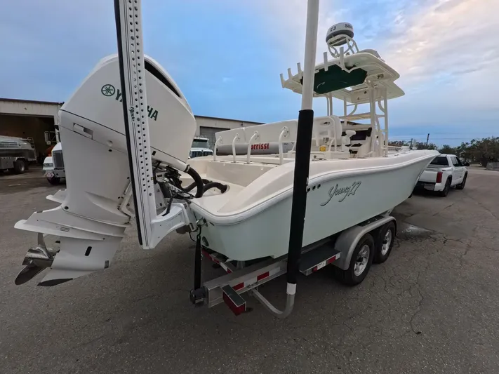  Yacht Photos Pics 2019 Young Boats 27 on trailer with Yamaha outboard motor, parked outdoors.