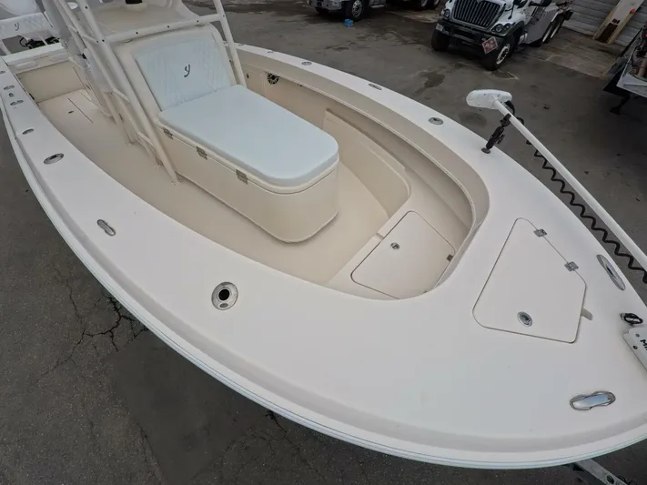  Yacht Photos Pics 2019 Young Boats 27 model, spacious deck with seating and storage, parked outdoors.