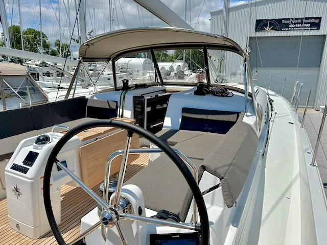 Jessy Yacht Photos Pics 2023 Jeanneau Sun Odyssey 490 sailboat cockpit with steering wheel and seating area.