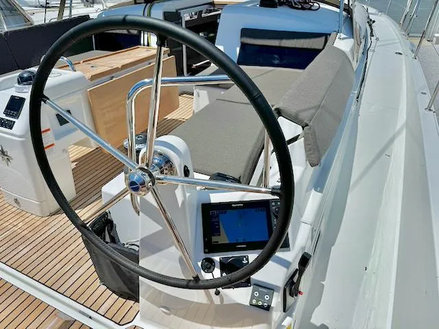 Jessy Yacht Photos Pics 2023 Jeanneau Sun Odyssey 490 yacht cockpit with steering wheel and navigation system.