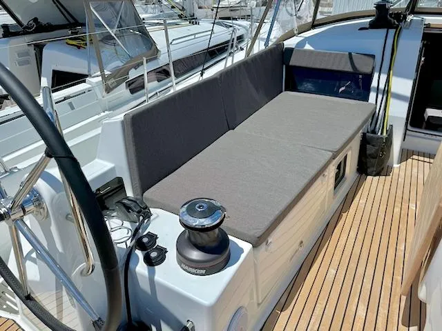 Jessy Yacht Photos Pics 2023 Jeanneau Sun Odyssey 490 yacht deck with seating and steering wheel.