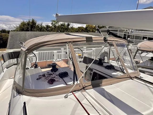 Jessy Yacht Photos Pics 2023 Jeanneau Sun Odyssey 490 sailboat with beige canopy and clear windows.