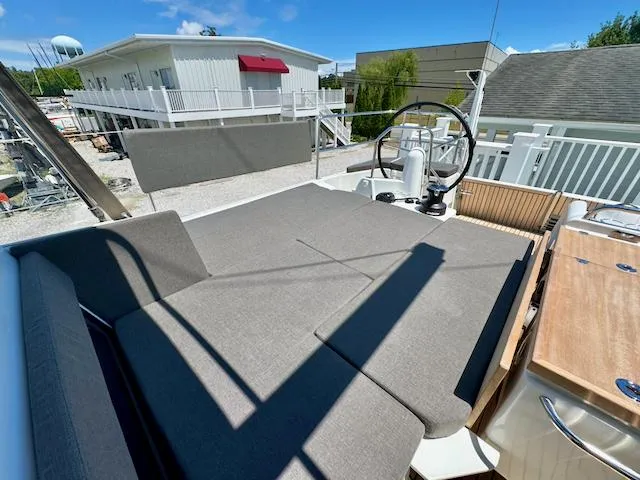 Jessy Yacht Photos Pics 2023 Jeanneau Sun Odyssey 490 yacht deck with steering wheel and seating area.