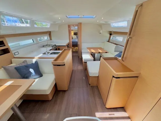 Jessy Yacht Photos Pics Luxurious interior of 2023 Jeanneau Sun Odyssey 490 yacht with modern furnishings.