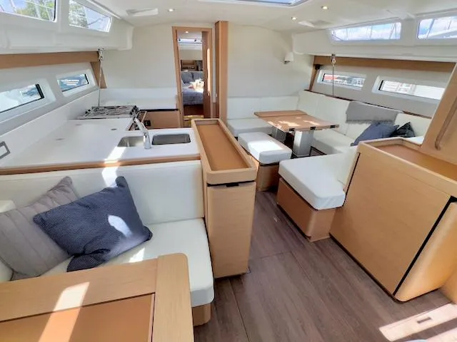 Jessy Yacht Photos Pics Interior of 2023 Jeanneau Sun Odyssey 490 yacht, featuring modern kitchen and dining area.