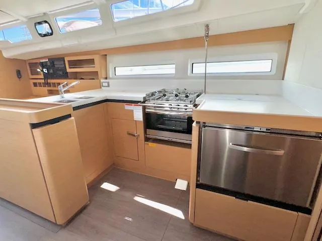 Jessy Yacht Photos Pics Modern kitchen in 2023 Jeanneau Sun Odyssey 490 yacht with sleek appliances and ample counter space.