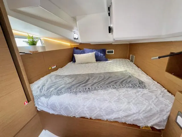Jessy Yacht Photos Pics Cozy cabin interior of 2023 Jeanneau Sun Odyssey 490 yacht with modern bedding.