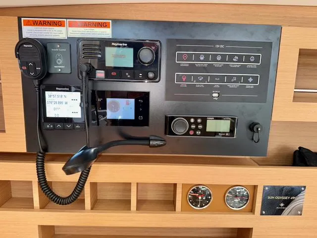 Jessy Yacht Photos Pics Control panel of 2023 Jeanneau Sun Odyssey 490 yacht with navigation and communication equipment.