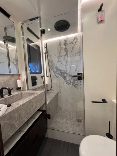  Yacht Photos Pics Luxurious bathroom in 2025 Astondoa AS 8 yacht with marble shower and modern fixtures.