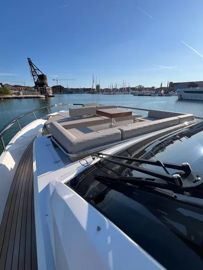  Yacht Photos Pics 2025 Astondoa AS 8 yacht with spacious deck, docked in a scenic marina.