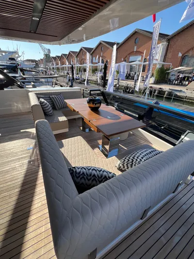  Yacht Photos Pics 2025 Astondoa AS 8 yacht deck with elegant seating and wooden table.