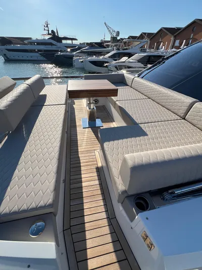  Yacht Photos Pics Luxurious 2025 Astondoa AS 8 yacht with elegant seating and sleek design in a marina setting.