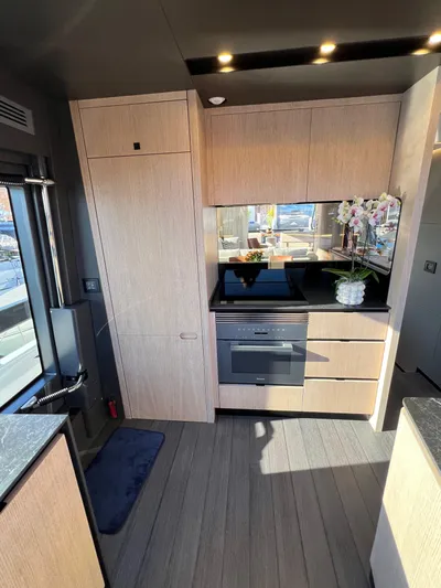  Yacht Photos Pics Modern kitchen interior of 2025 Astondoa AS 8 yacht with sleek cabinetry and appliances.