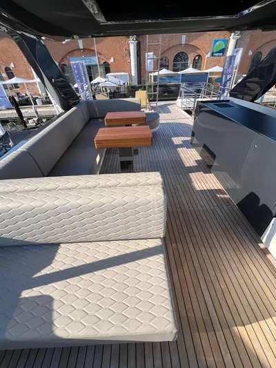  Yacht Photos Pics Luxurious 2025 Astondoa AS 8 yacht deck with elegant seating and wooden flooring.