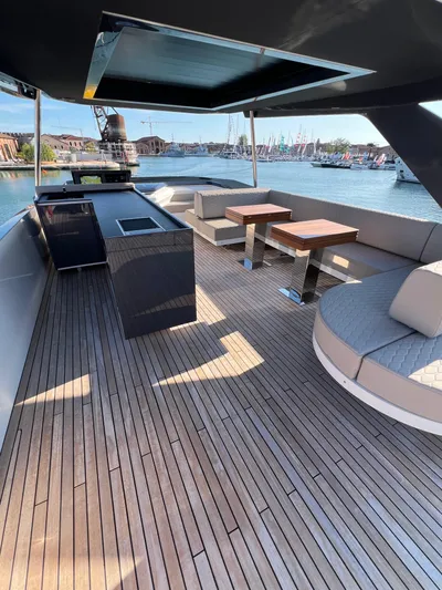  Yacht Photos Pics Luxurious 2025 Astondoa AS 8 yacht deck with seating and dining area, overlooking marina.