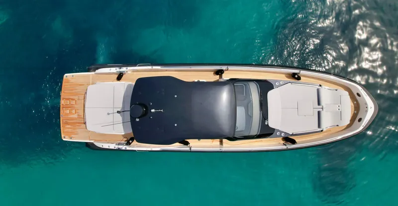 Rebel 47 Yacht Photos Pics Aerial view of 2025 SACS Rebel 47 yacht on clear blue water.