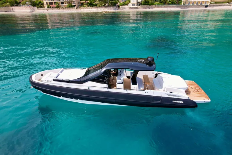 Rebel 47 Yacht Photos Pics 2025 SACS Rebel 47 luxury yacht on clear turquoise water.