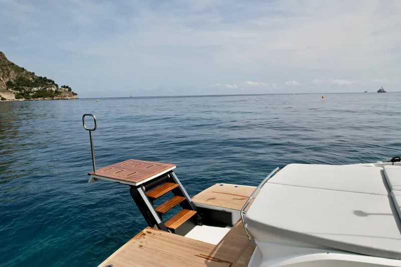 Rebel 47 Yacht Photos Pics 2025 SACS Rebel 47 yacht with swim platform on calm sea.