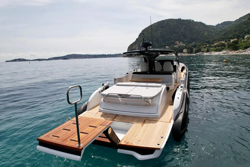 Rebel 47 Yacht Photos Pics 2025 SACS Rebel 47 yacht on serene waters with scenic mountain backdrop.